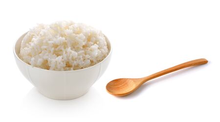 rice in a bowl and wooden spoon on white backgroundの写真素材