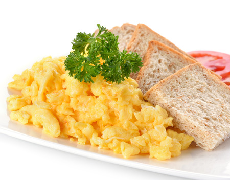 scrambled eggs with parsley,tomato and bread on white backgroundの写真素材