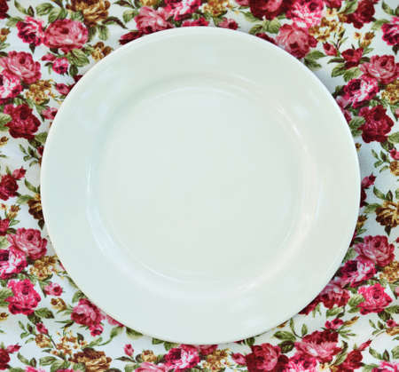 Empty plate at classic tablecloth.の写真素材