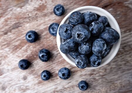 bowl of blueberries on wooden backgroundの写真素材