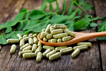 Moringa leaves and capsules (Herbs for health)の写真素材
