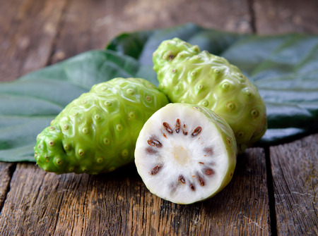 noni fruit on wooden backgroundの写真素材