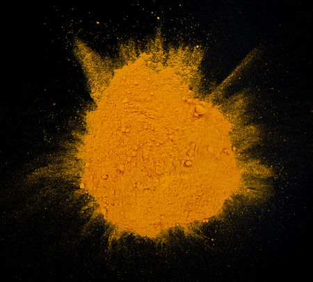 Turmeric powder on black background.の写真素材