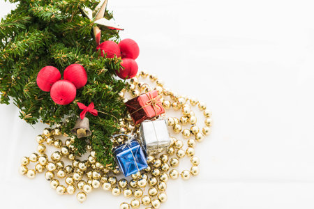 Christmas background with a red ornament, gift box, berries on white backgroundの写真素材