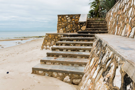 Weathered concrete stairs with mold, faded paint.,crumbling. on the beachの写真素材