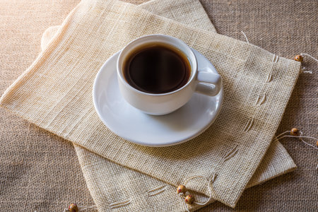 Cup of coffee on sackbag on sackclothの写真素材