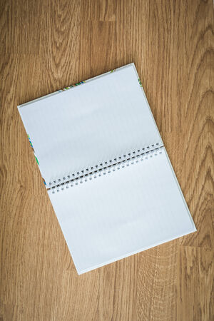a blank notebook on wooden backgroundの写真素材