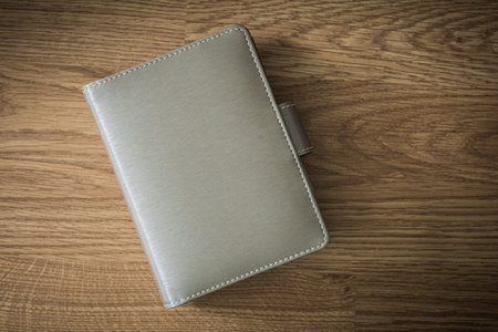 a blank notebook on wooden background