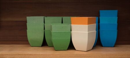 several flower pots on wooden shelfの写真素材