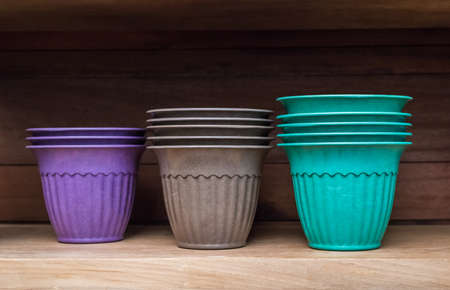 several flower pots on wooden shelfの写真素材