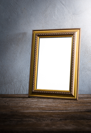 still life of luxurious photo frame on wooden table over grunge background. vintage toneの写真素材