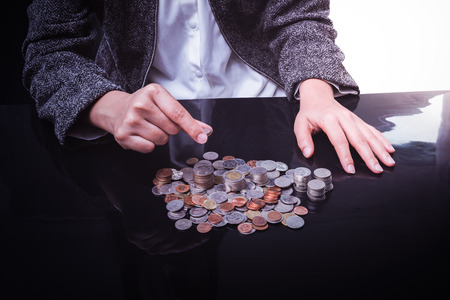 Closeup Of Businesswoman Hand Put Coins To Stack Of Coinsの写真素材