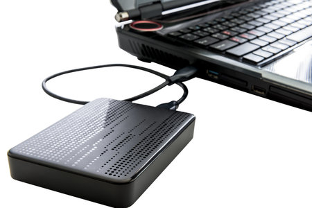 External hard drive connected to laptop on white background with clipping path
