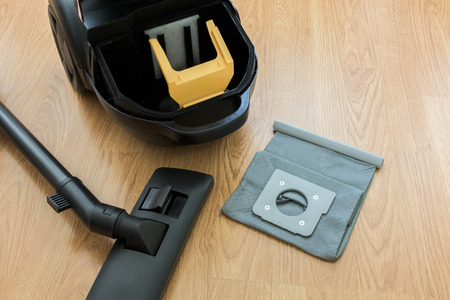 inside Vacuum cleaner and dust bag on the wooden floorの写真素材