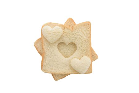 Heart shaped hole in a slice of bread isolated on white backgroundの写真素材