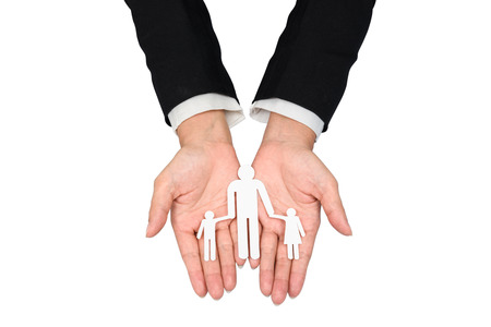 people, charity and care concept - close up of business woman hands holding paper family. isolated on white background with clipping pathの写真素材