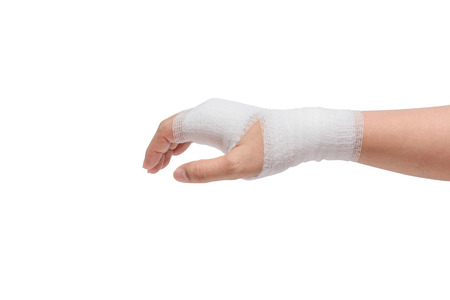 Injured painful hand with white gauze bandage. isolated on white background の写真素材