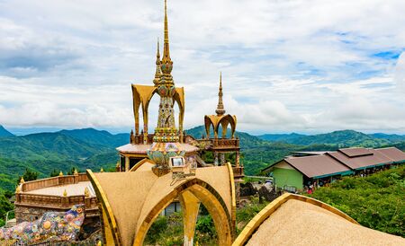 architecture of Wat Phra That Pha Son Kaew, PETCHRABOON province, THAILAND. buddhism crafts religions handwork on glass and ceramic tiles decoration on gold color pagoda surfaceの写真素材