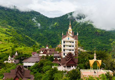 architecture of Wat Phra That Pha Son Kaew, PETCHRABOON province, THAILAND. buddhism crafts religions handwork on glass and ceramic tiles decoration on gold color pagoda surfaceの写真素材