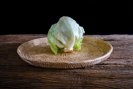 Green Iceberg lettuce on wooden tableの写真素材