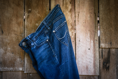 Vintage,Jeans Woman hanging on the wooden wall backgroundの写真素材