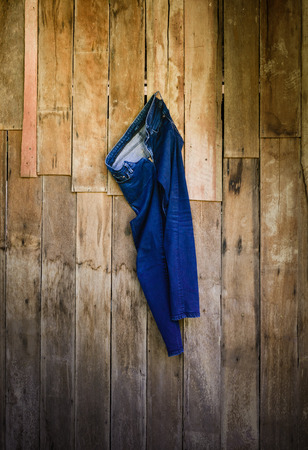 Vintage,Jeans Woman hanging on the wooden wall backgroundの写真素材