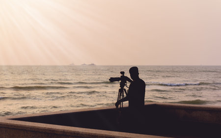 Silhouette photographer takes a good shot on the Huahin beach, Prachuap Khiri Khan, Thailand