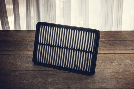 Spare parts. Air filter on the wooden workbench