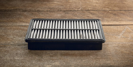 Spare parts. Air filter on the wooden workbench