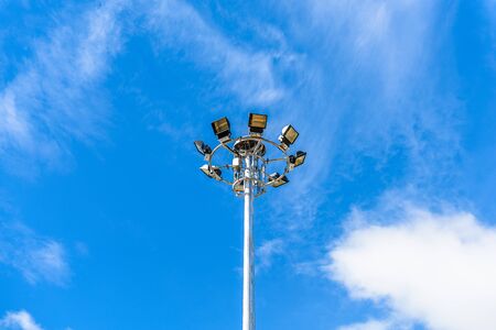 spotlight pole against blue sky and cloudの写真素材