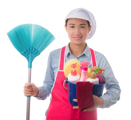 happy woman, maid, House wife  holding a bucket full of cleaning supplies isolated on white backgroundの写真素材