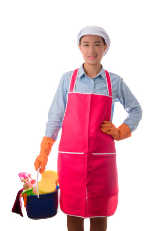 happy woman, maid, House wife  holding a bucket full of cleaning supplies isolated on white backgroundの写真素材