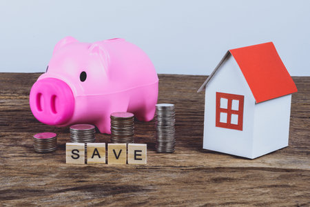 Paper house model, Piggybank and stack of coins with Words SAVE made block wooden letters. Wood abc. Time to Saving Concept