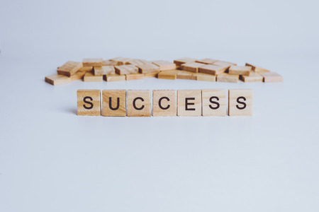 Words SUCCESS made with block wooden letters. Wood abc. on white tableの写真素材
