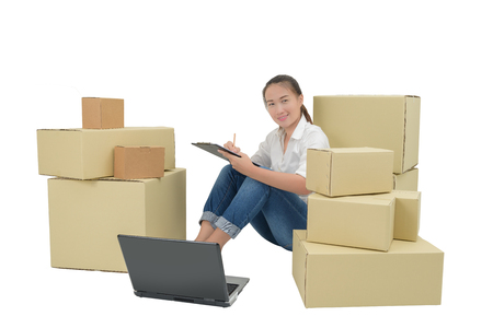 teenager owner business woman work at home with Clipboard, laptop for online shopping writing the order. isolated on white background with clipping pathの写真素材