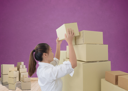 woman carrying and lifting boxes. moving house conceptの写真素材