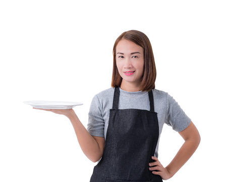 waitress, delivery woman or Servicewoman in Gray shirt and apron. hand holding empty white plate isolated on white background with clipping pathの写真素材