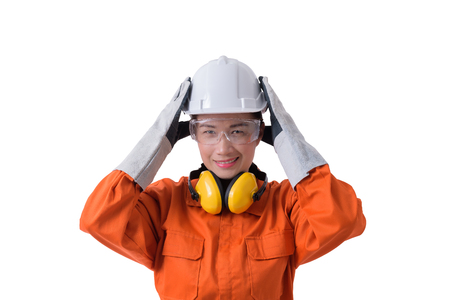 portrait of a woman worker in Mechanic Jumpsuit with helmet earmuffs Protective gloves and Safety goggles isolated on white background clipping pathの写真素材