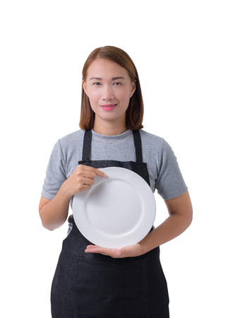 waitress, delivery woman or Servicewoman in Gray shirt and apron. hand holding empty white plate isolated on white background with clipping pathの写真素材