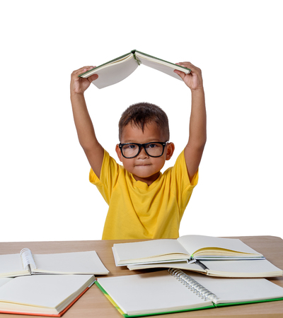 little girl with glasses thought and many book on the table. back to school concept, isolated on white background with clipping pathの写真素材