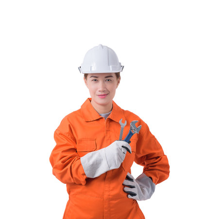 woman worker in Mechanic Jumpsuit is holding a wrench with helmet, earmuffs and Protective gloves...