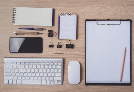 Workspace with diary or notebook and clipboard, mouse computer, keyboard, smart phone, pencil, pen...