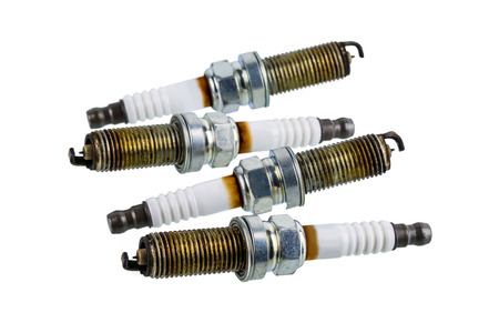Car spark plugs that have been used for more than 10,000 kilometers isolated on white background with clipping pathの写真素材
