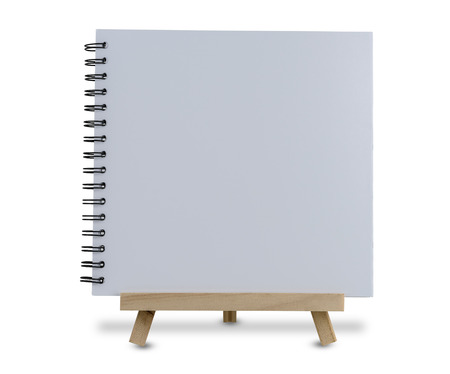 blank white notebook on wooden tripod standing isolated on white background with clipping pathの写真素材