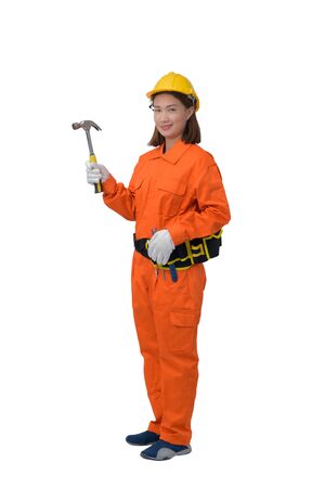 construction woman workers wearing Orange Protective clothes, helmet hand holding hammer with tool belt isolated on white background with clipping pathの写真素材
