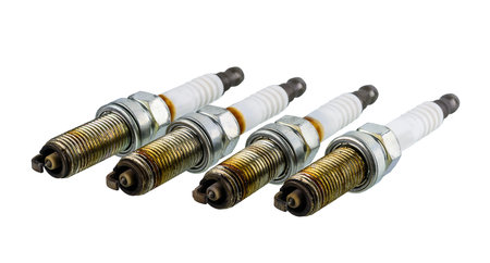 Car spark plugs that have been used for more than 10,000 kilometers isolated on white background...