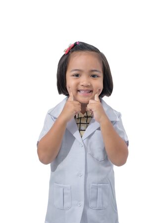 Cute Little asian girl doctor smiling while wearing Doctor's uniform. Standing isolated on white background with clipping pathの写真素材
