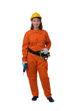 construction woman workers wearing Orange Protective clothes, helmet hand holding electric drill with tool belt isolated on white background with clipping pathの写真素材