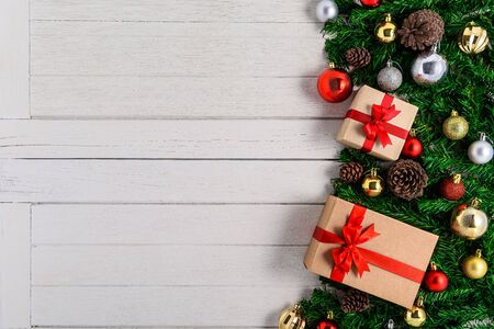 Christmas fir tree with decoration on white wooden board. Top view with copy spaceの写真素材