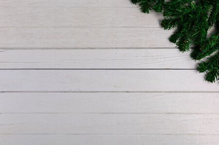 Fir branches on white wooden board. Christmas or New year backgroundの写真素材